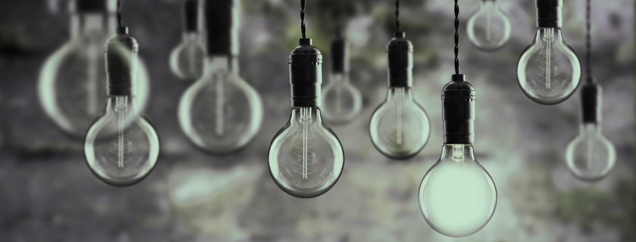 Idea and teamwork concept Vintage bulbs on wall background